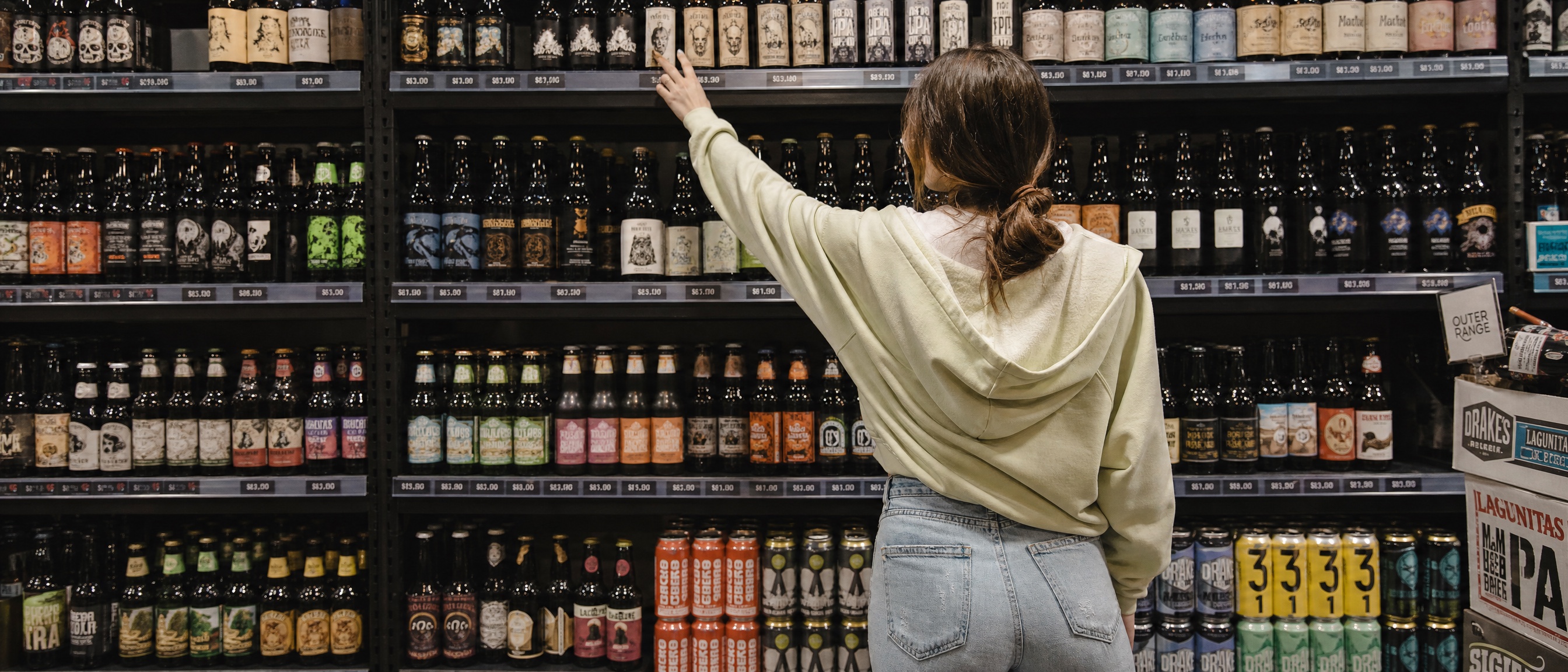 An independent shopper selecting an age-restricted product in a retail store